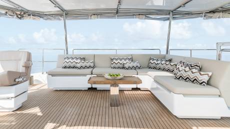Relax on the spacious deck of a luxury yacht, enjoying the ocean breeze and stunning views.