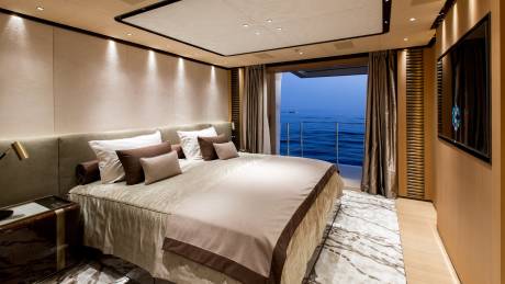 Luxurious yacht bedroom with a stunning ocean view and plush bedding offers ultimate comfort and serenity.