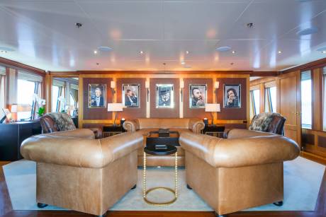 Luxurious leather seating and framed portraits create a sophisticated lounge aboard this elegant yacht.