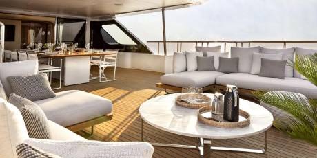 Relax on the luxurious deck of a yacht, enjoying the ocean breeze and stunning sunset views.