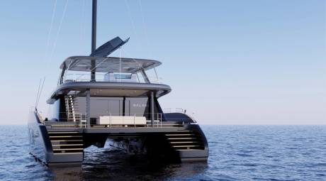 A sleek, modern catamaran yacht named Nalani glides across the calm, blue ocean under a clear sky.