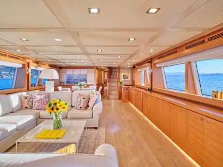 Luxurious yacht interiors offer stunning ocean views from plush seating areas and elegant dining spaces.