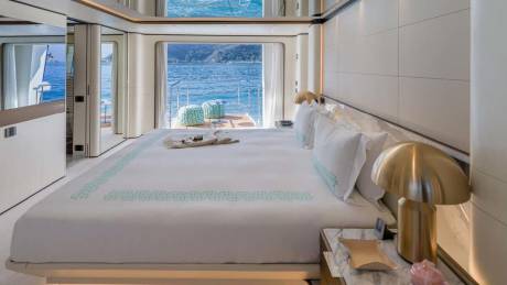 Wake up to breathtaking ocean views from this luxurious yacht bedroom with direct access to the deck.
