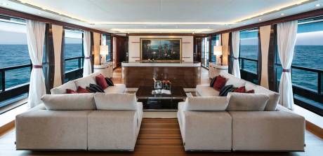 Luxurious yacht interiors offer breathtaking ocean views through expansive windows, creating a serene and elegant living space at sea.
