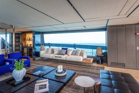Luxurious yacht interiors offer breathtaking ocean views from a spacious lounge with plush seating and a well-stocked bar.