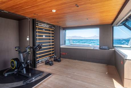 This yacht's gym offers a scenic workout with stunning ocean views and modern equipment.