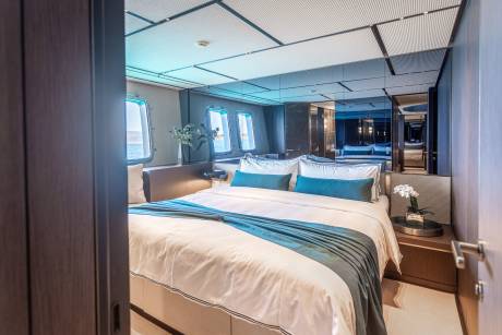 Luxurious yacht stateroom offers a serene escape with ocean views and elegant decor.