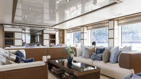 Luxurious yacht interiors offer stunning ocean views through large windows, creating a serene and elegant atmosphere.