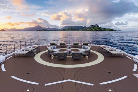 Luxurious yacht deck offers a serene setting for enjoying a tropical sunset over the ocean.