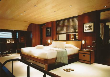 Luxurious wood paneling and plush bedding create a serene retreat aboard this elegant yacht.