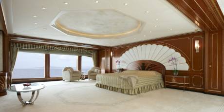 Luxurious yacht bedroom offers stunning ocean views and opulent decor for ultimate relaxation.