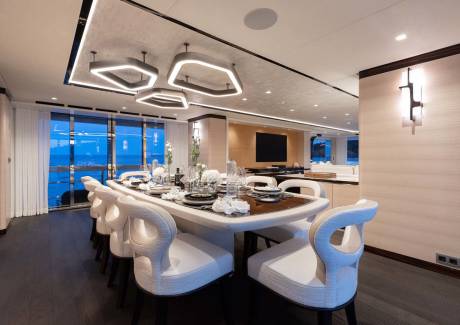 A luxurious yacht dining room offers a sophisticated setting for a meal overlooking the ocean.