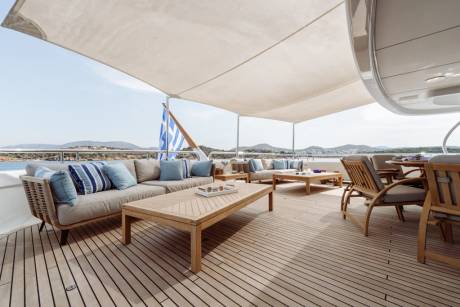 Relax on the spacious deck of this luxury yacht, complete with comfortable seating and stunning ocean views.