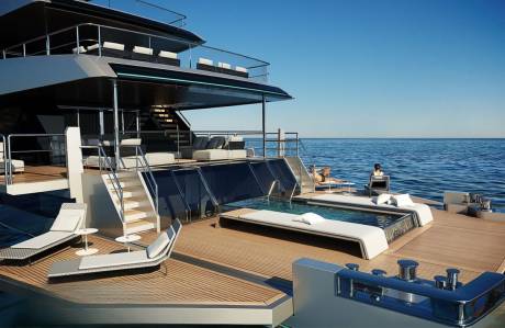 Luxurious yacht deck features a serene pool, sun loungers, and plush seating overlooking the tranquil blue ocean.