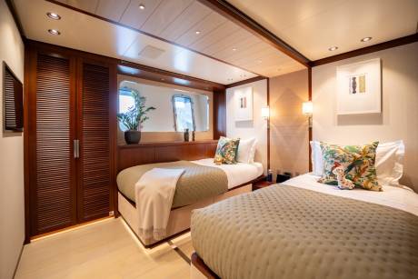 Twin beds with patterned pillows and cozy blankets await in this elegantly appointed cabin.