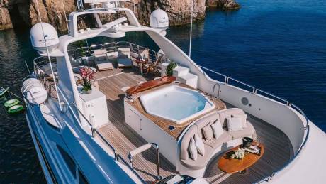 Relax in the onboard jacuzzi and lounge areas of this luxurious yacht while surrounded by stunning coastal scenery.