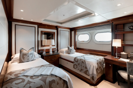 Luxurious twin beds with plush bedding and elegant decor create a serene retreat on this opulent yacht.