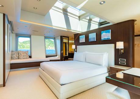 Luxurious yacht bedroom with skylights and ocean views offers a serene escape.