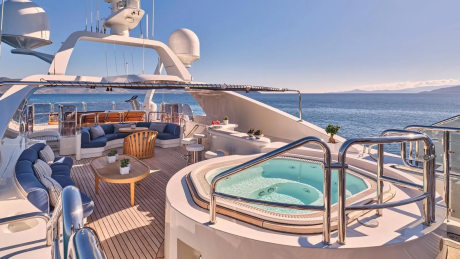 Relax in the onboard jacuzzi with stunning ocean views from this luxurious yacht deck.